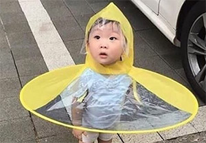 Hands-free umbrella kid living in 3017 meme costume